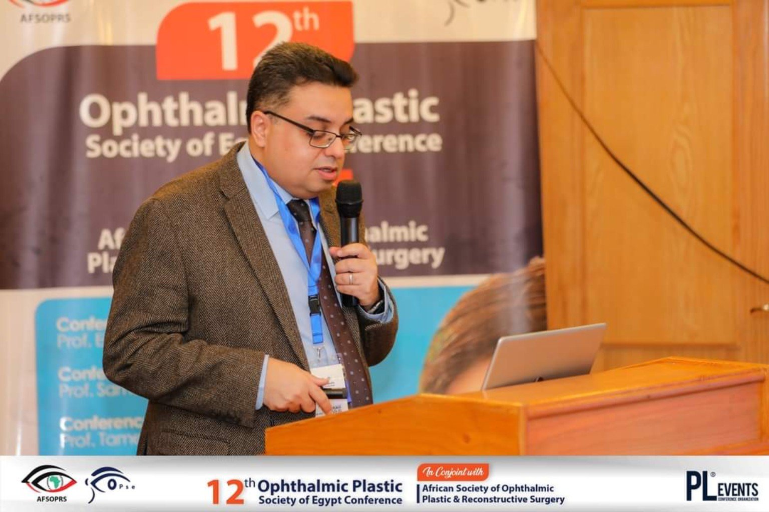 أ.د. سامح حسن يتحدث بالميكروفون في مؤتمر Ophthalmic Plastic Society of Egypt الثاني عشر.